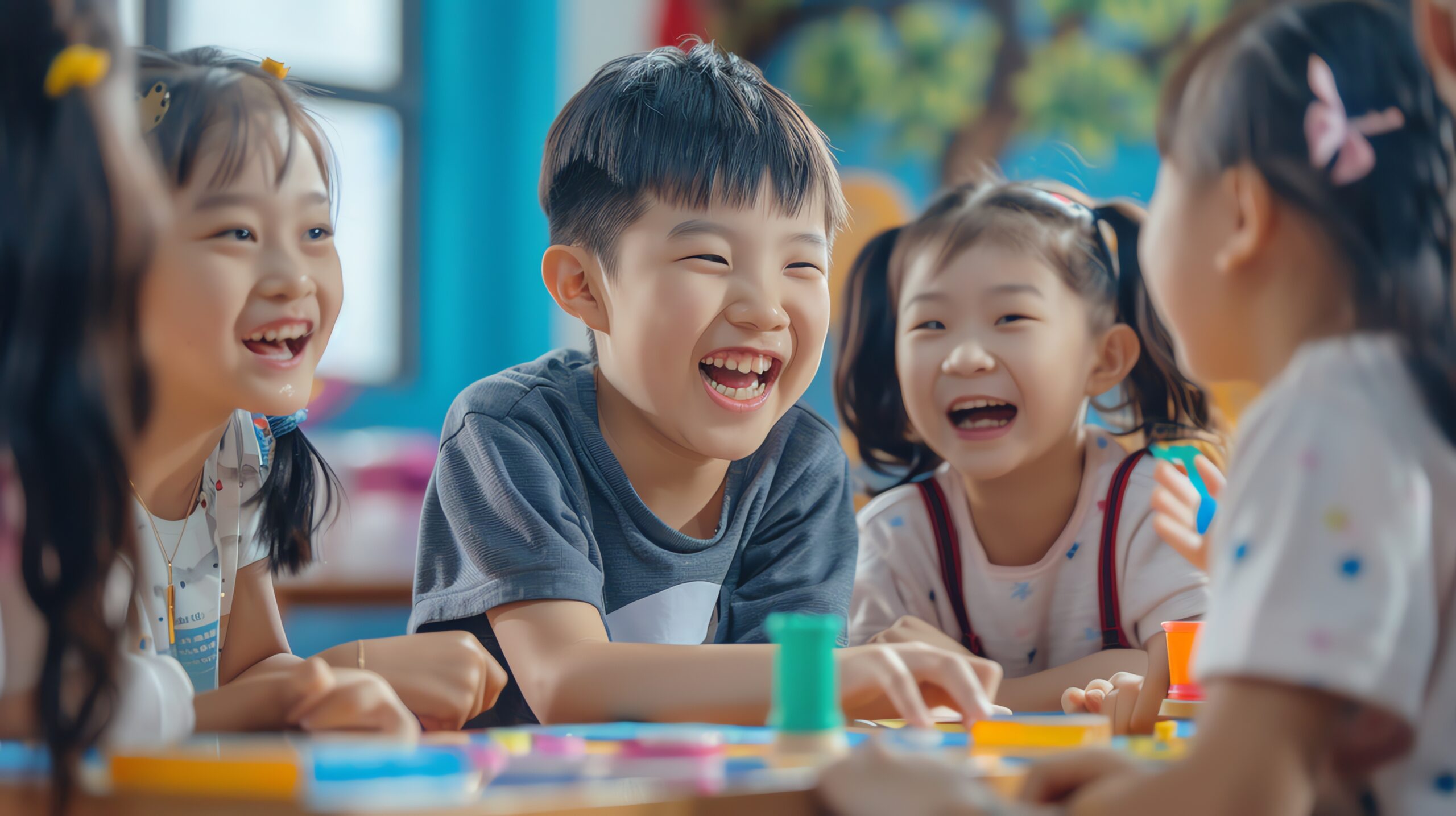 group happy children laughing together while playing classroom scaled